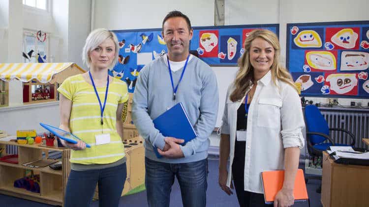 Two women and a man in preschool classroom