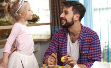 Father looking at toddler dresses as ballerina