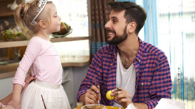 Father looking at toddler dresses as ballerina