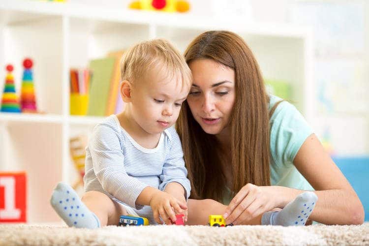 Mother and infant playing with toys