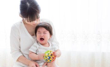 Woman holding crying infant