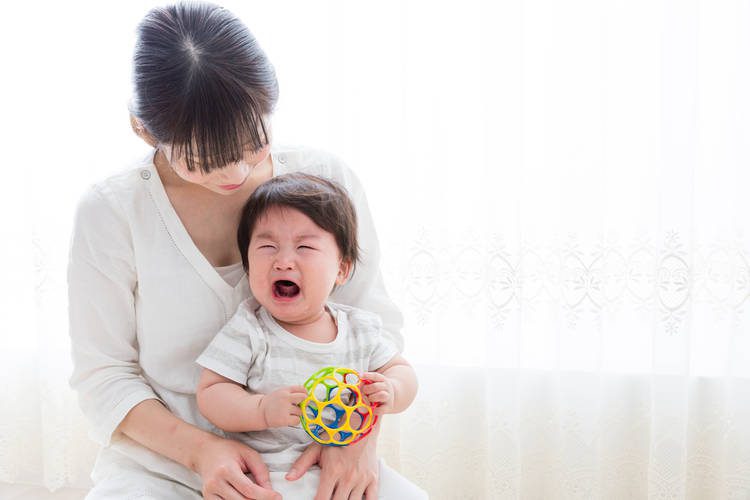Woman holding crying infant