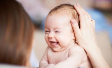 Person holding laughing infant