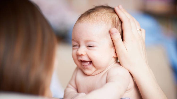 Person holding laughing infant