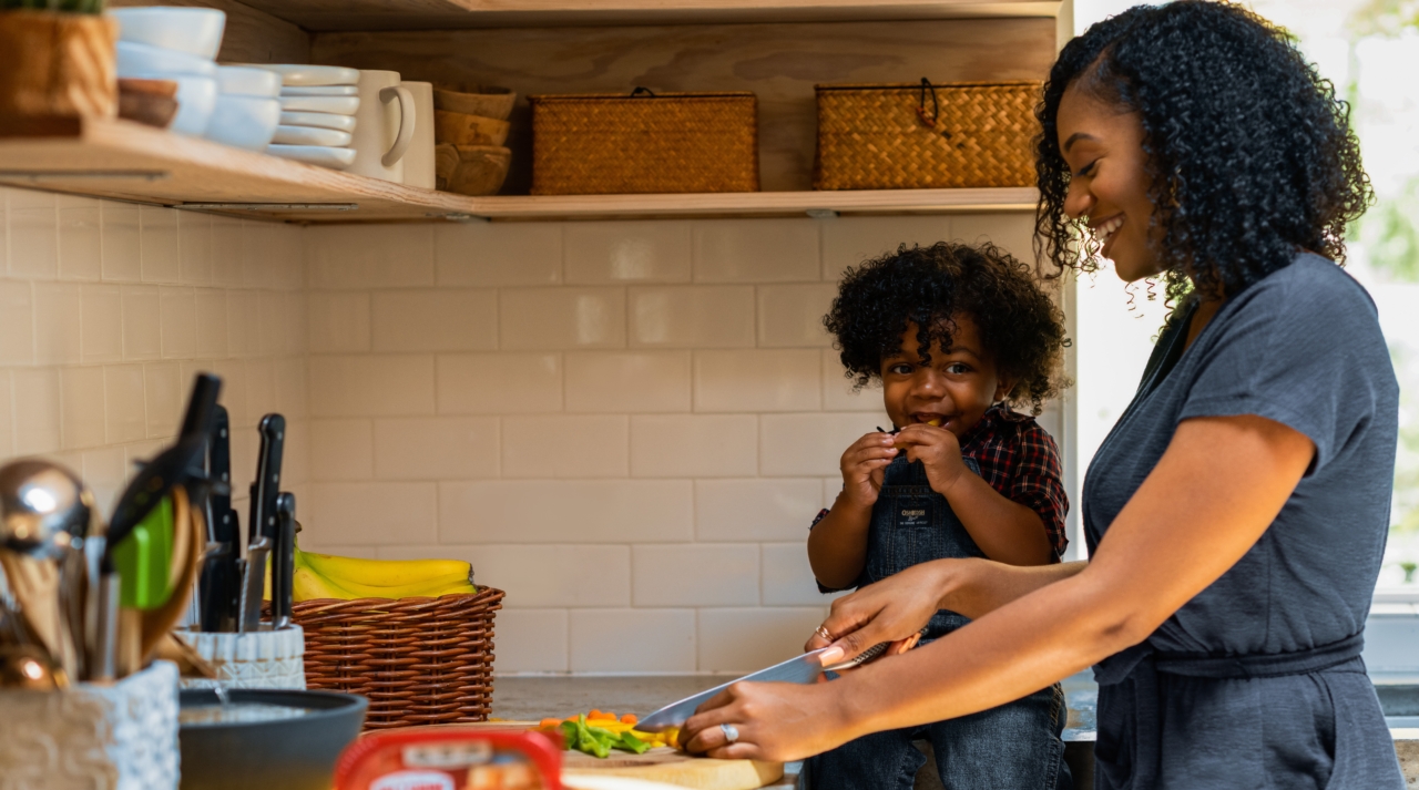 Mom cooks with child, black family