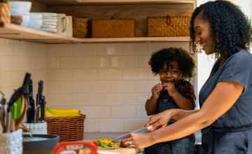 Mom cooks with child, black family