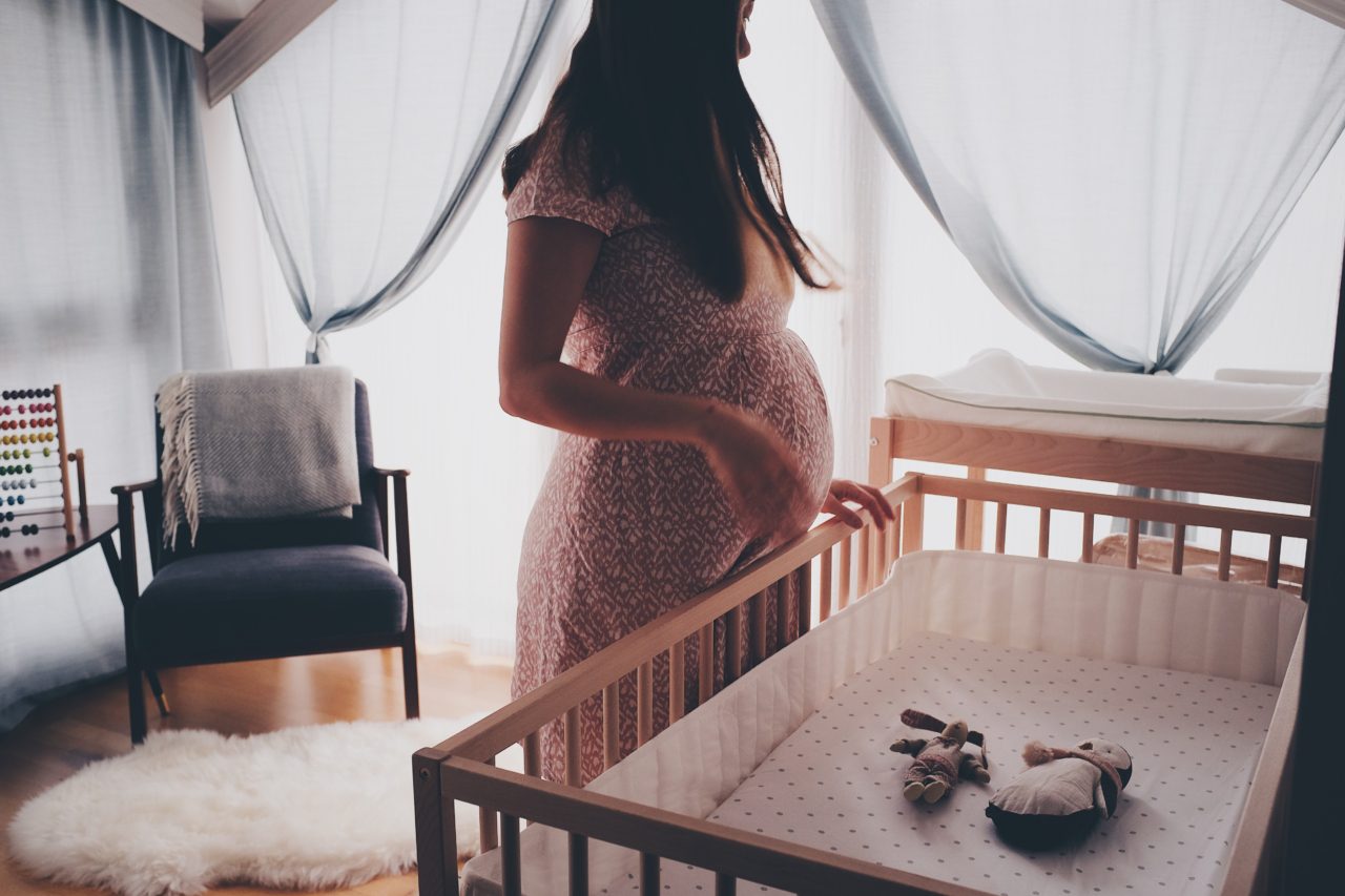 pregnant woman and crib