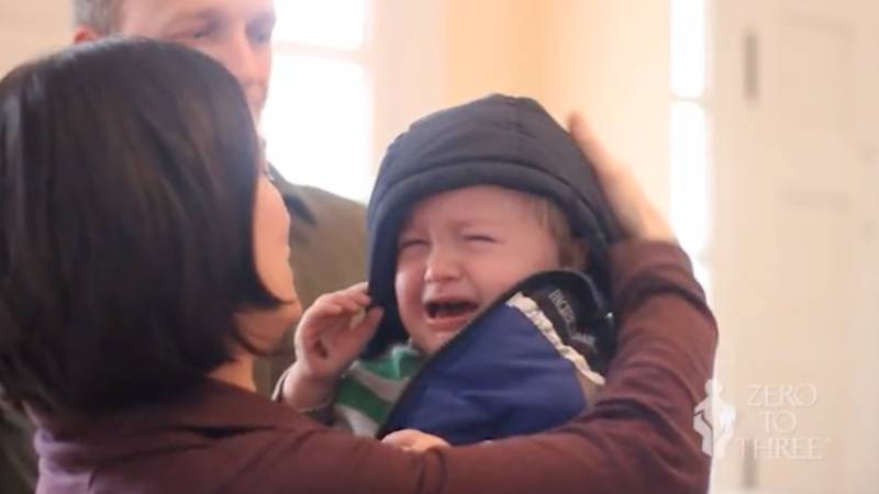 Mother Holding a Crying Toddler