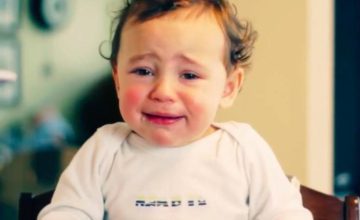 Upset young child in high chair