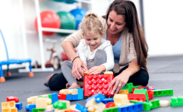 adult and child playing with blocks