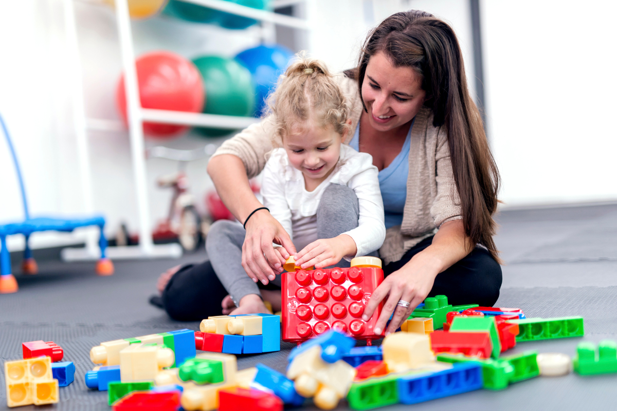 adult and child playing with blocks