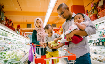 parents and two babies grocery shopping
