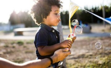 toddler blowing bubbles