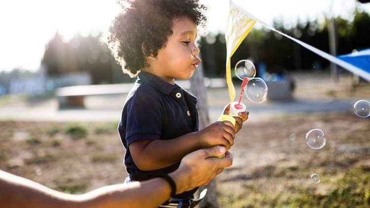 toddler blowing bubbles