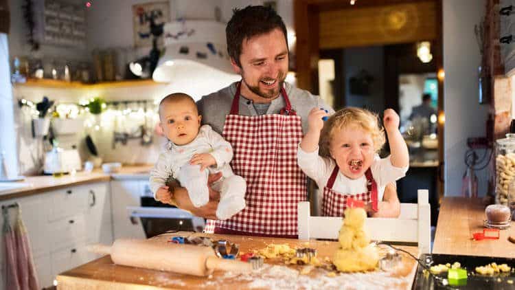 toddlers playing in kitchen with dad