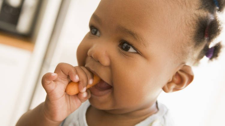 baby eating carrot