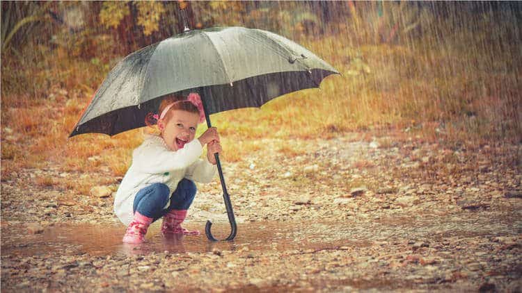 toddler playing in the rain