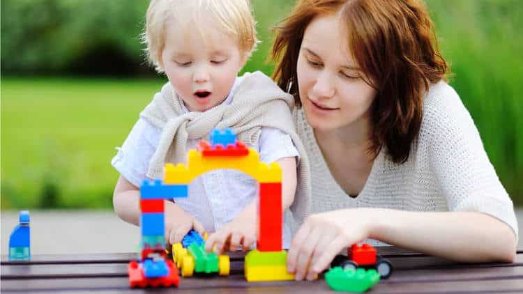 toddler playing with toy car