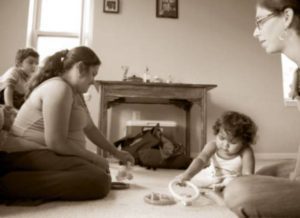 People in romm with child playing on floor