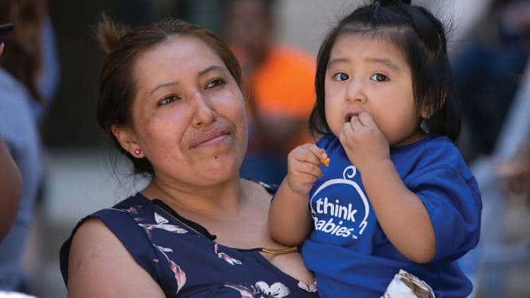 Woman carrying child