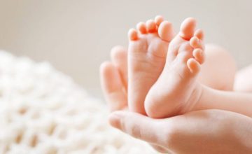 Hands holding a baby's feet