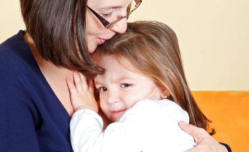 Caregiver comforting a shy child