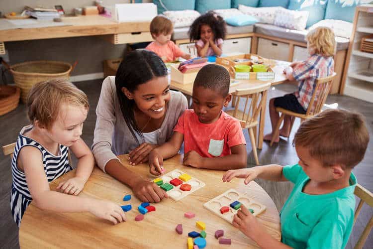 Child care professionals with toddlers playing