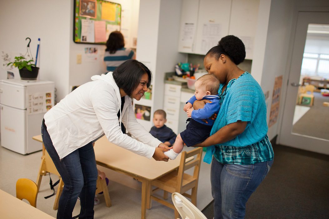 woman playing with baby's feet