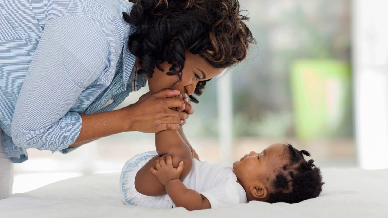 woman kisses baby feet