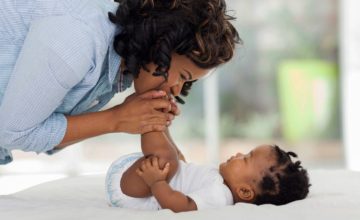 woman kisses baby feet