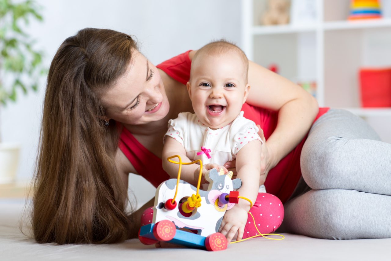 baby laughing and playing on floor