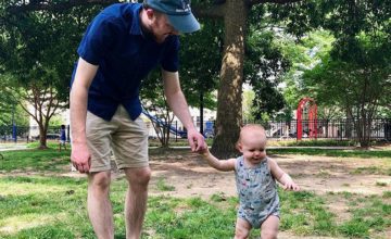 man and child playing at park