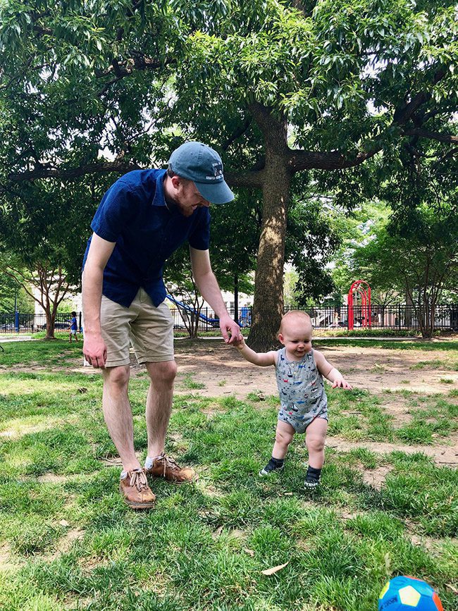 man and child playing at park