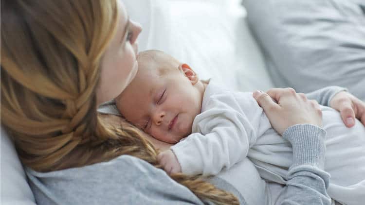 Mother holding smiling baby
