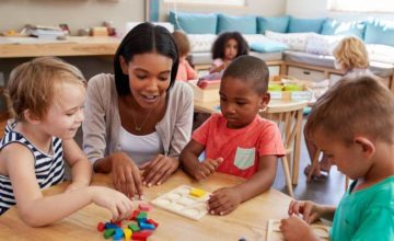 Child care professional with toddlers playing and learning