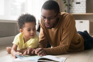 A father reads to his child.