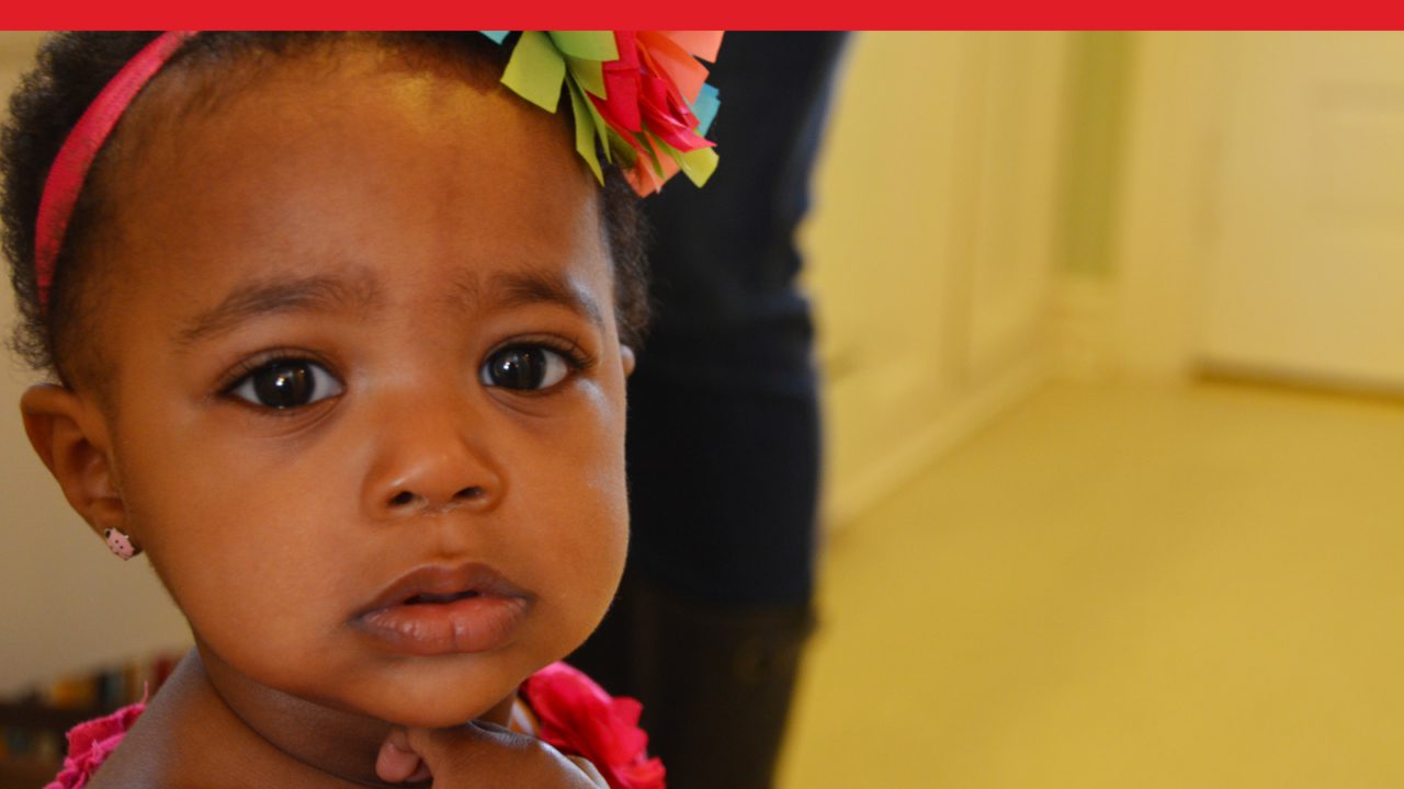 toddler with flower in hair