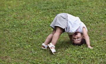 Toddler playing on the grass