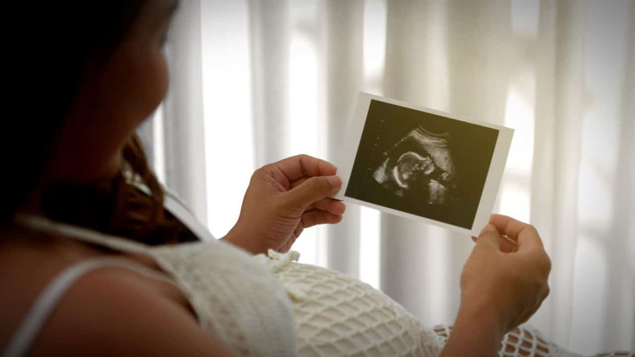 mother holds sonogram