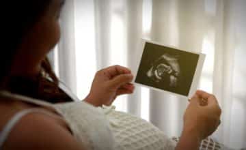 mother holds sonogram