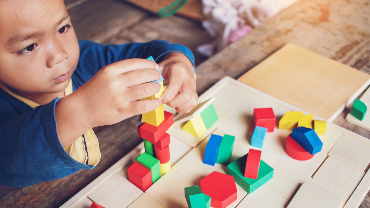 Young child building with blocks