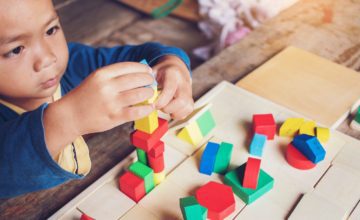 Young child building with blocks