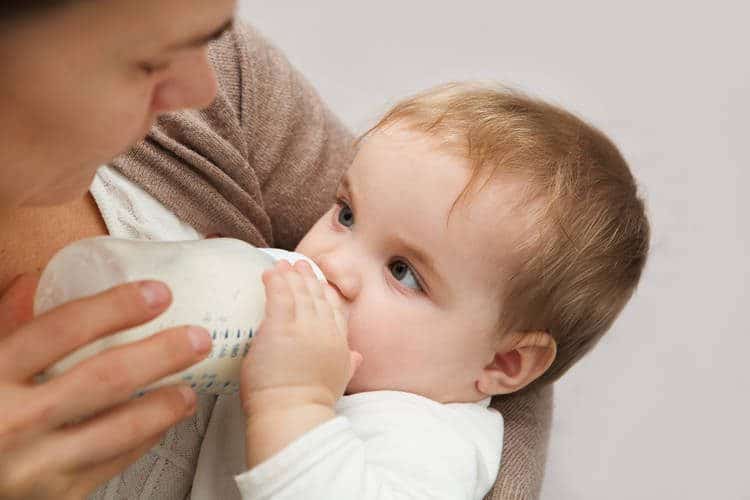 mom bottle feeding baby