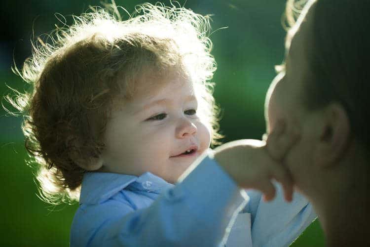 baby playing with mom