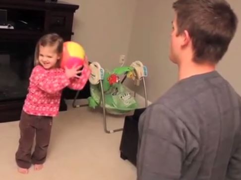 daughter throwing toys at father