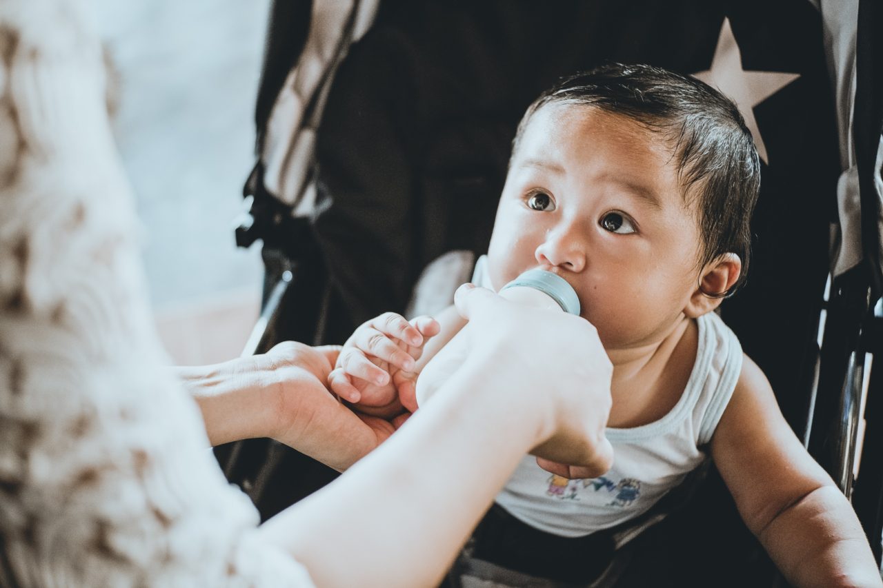 parents feeding baby