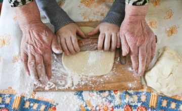 grandparent and toddler making dough