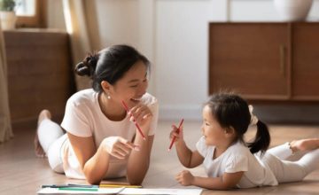 Mother and toddler drawing together