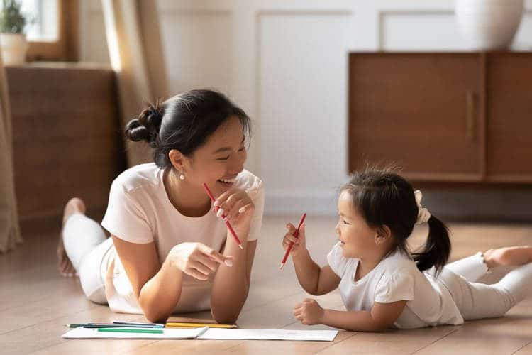 Mother and toddler drawing together