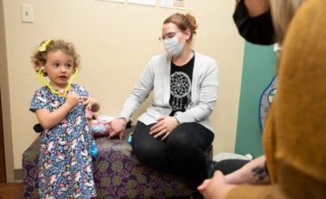 Young girl with mother at pediatrician visit